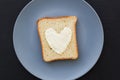 sandwich for breakfast in form of heart with cheese on a blue plate and black background Royalty Free Stock Photo