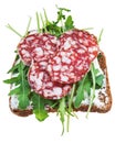 Sandwich from brown bread, salami and green salad