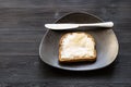 Sandwich with buttered butter and knife on black Royalty Free Stock Photo