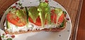 Sandwich with cheese, tomatoes, lettuce and herbs