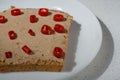 Sandwich with chicken meat spread or paste, hot red chilli pepper slices on white plate, close up shot, top view. Tasty snack, Royalty Free Stock Photo