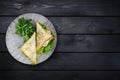 Sandwich with chicken and vegetables on a ceramic plate. On black wooden background. Top view, copy space for your text Royalty Free Stock Photo