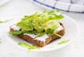 Sandwich of cream cheese bread and slices of avocado