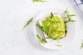 Sandwich of cream cheese bread and slices of avocado