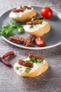 Sandwich with cream cheese and dried tomatoes on a plate