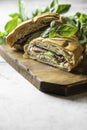 Sandwich croissant with cucumber, avocado, tomato, spinach, beef pastrami, sauce on wooden board. Royalty Free Stock Photo