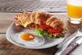 Sandwich croissant with fried bacon cheese tomato breakfast and egg Royalty Free Stock Photo