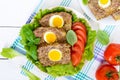 Sandwich with egg poached, lettuce, black bread with seeds, tomatoes, sweet pepper Royalty Free Stock Photo