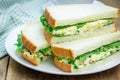Sandwich with egg salad, bacon, green onion, lettuce