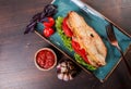 Sandwich with fillet grilled chicken, lettuce, tomatoes, cheese and traditional bread loaf out of the oven on dark background. Royalty Free Stock Photo