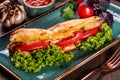 Sandwich with fillet grilled chicken, lettuce, tomatoes, cheese and traditional bread loaf Royalty Free Stock Photo