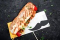 Sandwich from fresh pita bread with fillet grilled chicken and vegetables on dark wooden background. Royalty Free Stock Photo