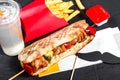 Sandwich from fresh pita bread with fillet grilled chicken and vegetables on dark wooden background. Royalty Free Stock Photo