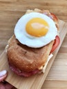 Sandwich with a fried egg, bacon, cheese and vegetables Royalty Free Stock Photo