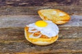 Sandwich with a fried egg, bacon, cheese and vegetables. Royalty Free Stock Photo