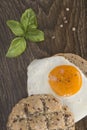 Sandwich with a fried egg on a wooden table.