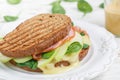 Sandwich with ham, brie cheese or Camembert, spinach, Apple and mustard Royalty Free Stock Photo