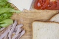 Sandwich with ham, cheese, tomatoes, lettuce, and toasted bread. Above view on white background Royalty Free Stock Photo