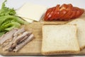 Sandwich with ham, cheese, tomatoes, lettuce, and toasted bread. Above view on white background Royalty Free Stock Photo