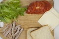 Sandwich with ham, cheese, tomatoes, lettuce, and toasted bread. Above view on white background Royalty Free Stock Photo