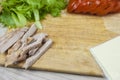 Sandwich with ham, cheese, tomatoes, lettuce, and toasted bread. Above view on white background Royalty Free Stock Photo