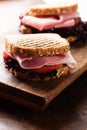 Sandwich with ham salad tomato on cutting board macro Royalty Free Stock Photo