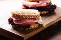 Sandwich with ham salad tomato on cutting board Royalty Free Stock Photo