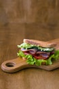 Sandwich with ham and vegetables.tasty sandwich with ham, green salad, cucumbers and tomatoes Royalty Free Stock Photo