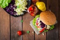 Sandwich hamburger with juicy burgers, cheese and mix of cabbage. Royalty Free Stock Photo