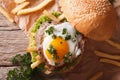 Sandwich with meat, a fried egg and fries close-up. horizontal t Royalty Free Stock Photo