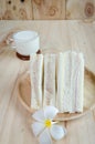 Sandwich with milk on wood background