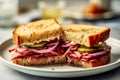 Sandwich with pastrami pickles and red onions on toasted sourdough bread on white plate. Nutritious food balanced diet