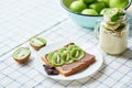 Sandwich with peanut butter and kiwi, green apples, yogurt with banana and kiwi, creative idea for kids breakfast, dessert or Royalty Free Stock Photo