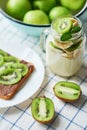 Sandwich with peanut butter and kiwi, green apples, yogurt with banana and kiwi, creative idea for kids breakfast, dessert or Royalty Free Stock Photo