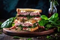 sandwich piled high with deli meat and fresh mint leaves