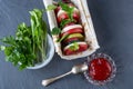 Sandwich with pita bread, tomatoes, mozzarella, apples, cucumber, radish, adjika and greens arugula and parsley