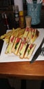 Sandwich Plate with Eight Pieces of it and French Fries and Fork and Knife