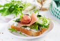 Sandwich with prosciutto, cucumber, black olives, arugula and feta cheese