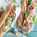 Sandwich prosciutto mascarpone cheese figs wooden table top view