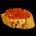 Sandwich with red caviar from white fresh bread with butter,isolated on a black background,seafood from fish,healthy fish oil Royalty Free Stock Photo