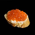 Sandwich with red caviar from white fresh bread with butter,isolated on a black background,seafood from fish,healthy fish oil Royalty Free Stock Photo