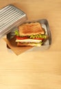 Sandwich in a retro tin box on wooden table