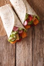 Sandwich roll with fishfingers, cheese and vegetables closeup. v Royalty Free Stock Photo