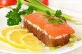 Sandwich with salmon, lemon slices and parsley