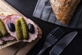 Sandwich with sausage , gherkin and black olives. A tasty snack