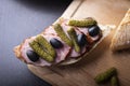 Sandwich with sausage , gherkin and black olives. A tasty snack