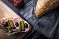 Sandwich with sausage , gherkin and black olives. A tasty snack