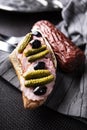 Sandwich with sausage , gherkin and black olives. A tasty snack