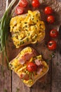 sandwich with scrambled eggs, bacon and tomatoes close-up. Vertical top view