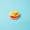 Sandwich of slices of orange, grapefruit, lemon and lime on a blue background Royalty Free Stock Photo